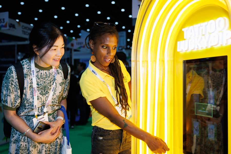 Two women looking at a product on the trade show floor